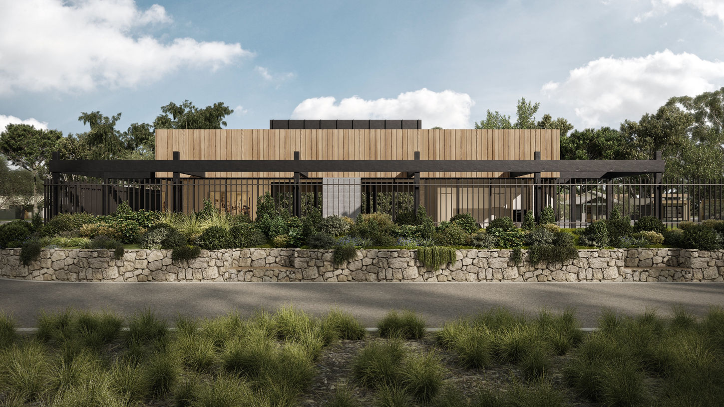 Modern single-story house with large windows set against a dramatic cloudy sky