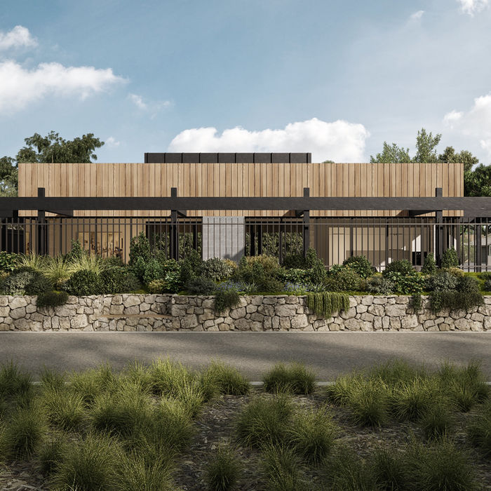 Modern single-story house with large windows set against a dramatic cloudy sky