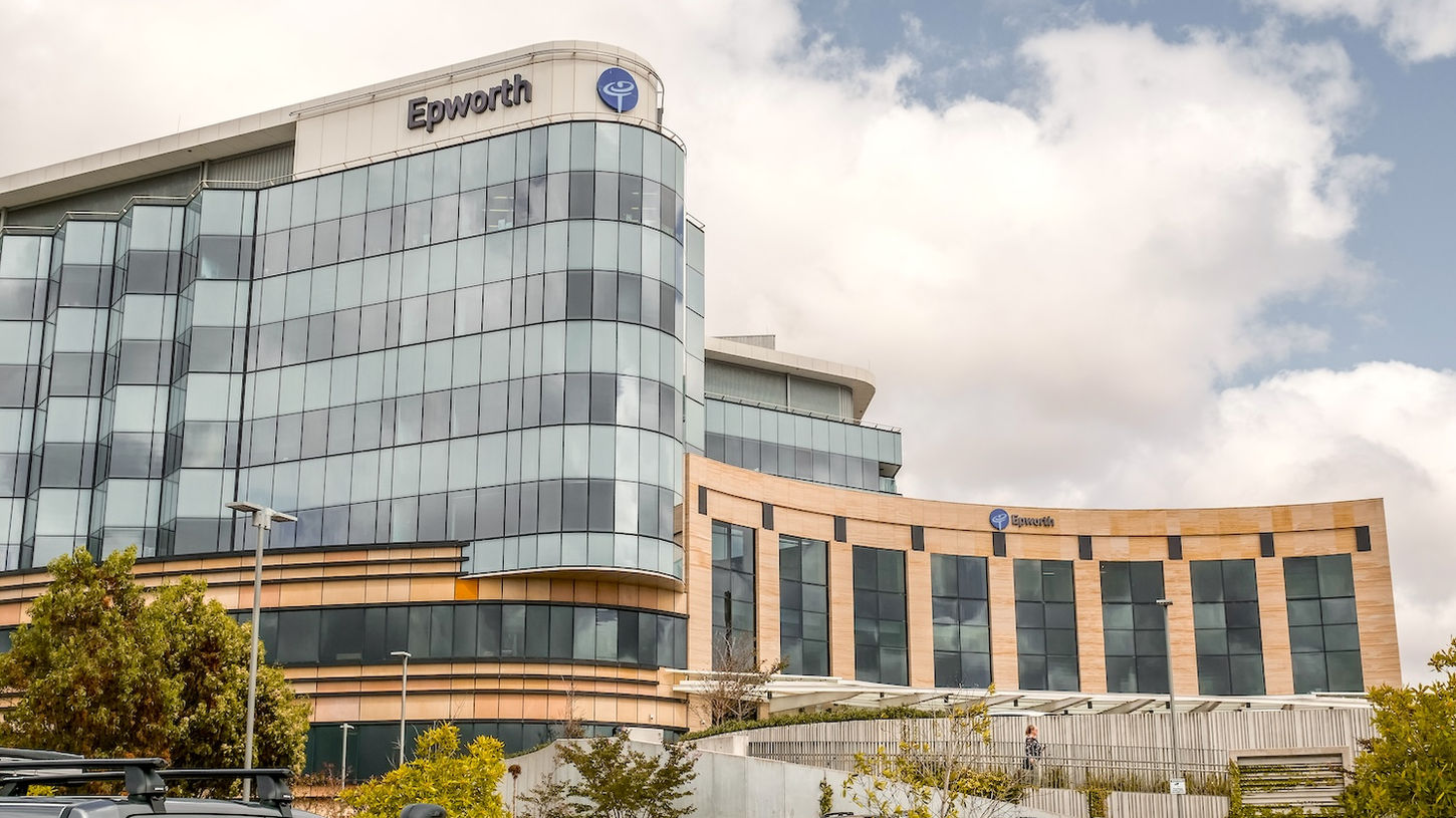 Epworth hospital building exterior with multi-storey glass facade and car park