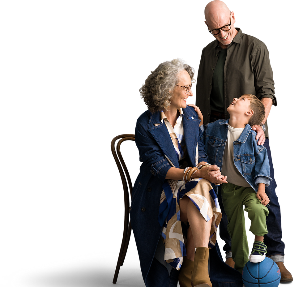 Grandparents smiling with young grandson in a studio portrait